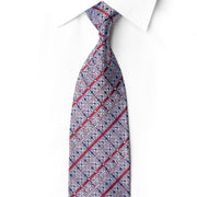 San-Dee EC139 silk necktie knotted against a white shirt, with silver-gray geometric motifs, crimson diagonal stripes and sparkling rhinestones.