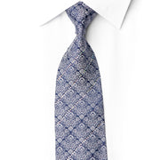 Close-up of San-Dee navy silk necktie with intricate silver floral pattern and crystal rhinestones