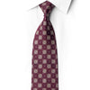San-Dee burgundy silk necktie knotted against a white shirt, with ornate gold-toned lattice motifs and crystal rhinestone dots.