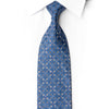 San-Dee blue silk necktie laid diagonally on white fabric, with silver-outlined diamond motifs and crystal rhinestone accents.