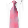 San-Dee pink silver diamond geometric silk necktie worn with white dress shirt, showing full length jacquard weave detail