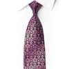 San-Dee purple and pink floral scrollwork silk necktie with crystal rhinestones and silver accents, laid diagonally on white.