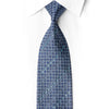 San-Dee navy silk necktie knotted against a white shirt, with silver circular rosettes and aqua-reflecting crystal rhinestones.