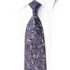 San-Dee navy rhinestone silk tie knotted against a white shirt, showing brown botanical leaves, silver vines and sparkling crystal details.