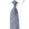 Close-up of San-Dee navy silk necktie with intricate silver floral pattern and crystal rhinestones