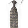 Folded midnight navy silk necktie with silver floral scrollwork and scattered crystal rhinestones