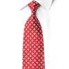 Red medallion rhinestone silk necktie worn on white dress shirt, front view showing ornate quatrefoil pattern with silver crystal accents